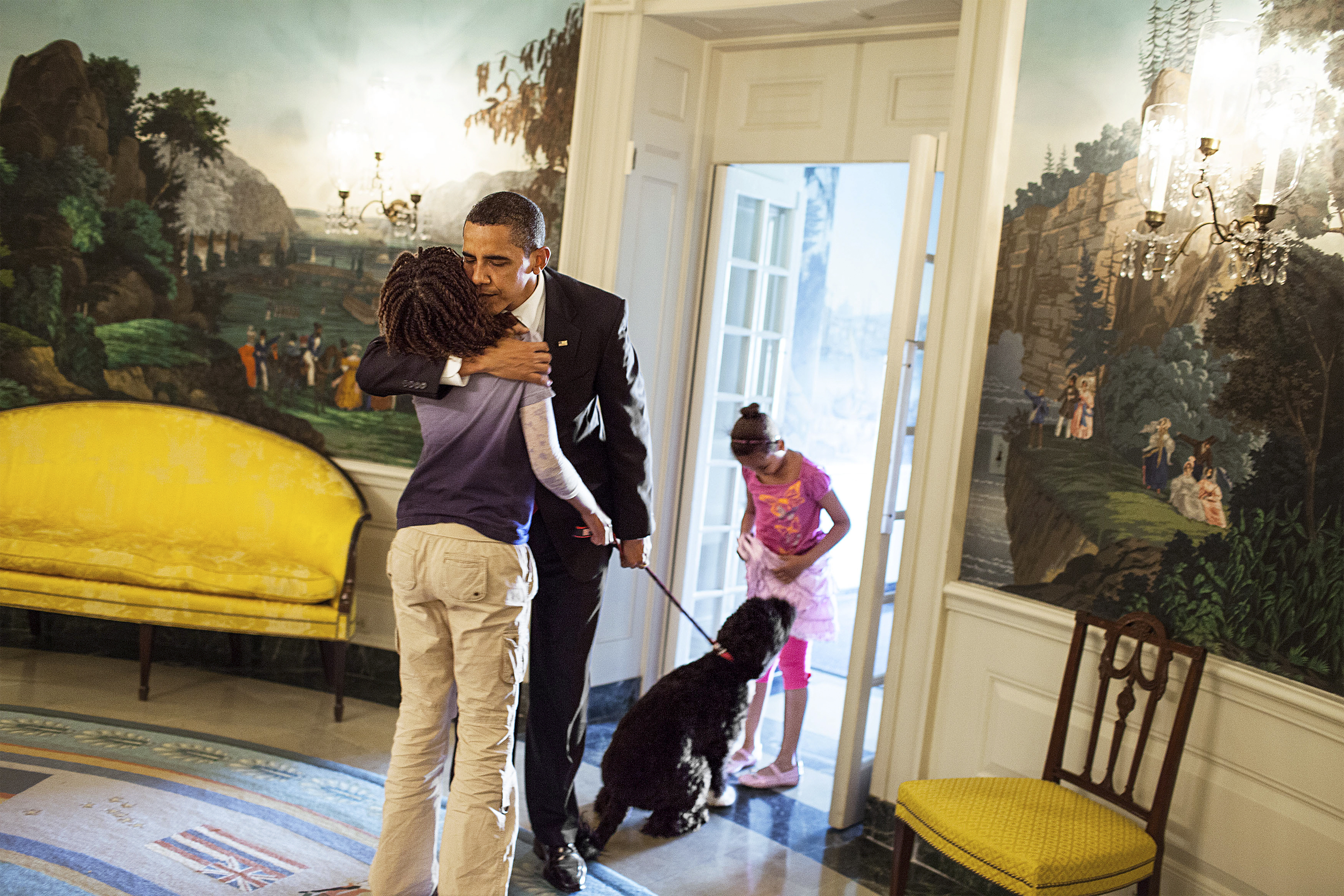 President Barack Obama says goodbye to daughters Sasha and Malia Obama in the Diplomatic Reception Room of the White House before his departure to Arizona, May 13, 209. (Official White House Photo by Samantha Appleton) This photograph is provided by THE WHITE HOUSE as a courtesy and is for one time use only with the MORE Magazine article with First Lady Michelle Obama. This photograph may not be used online or archived. This photograph may not be manipulated in any way and may not otherwise be reproduced, disseminated, or broadcast without the written permission of the White House Photo Office. This photograph may not be used in any commercial or political materials, advertisements, emails, products, promotions that in any way suggests approval or endorsement of the President, the First Family, or the White House.