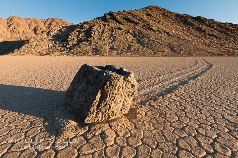Sailing stone on the Racetrack Playa. The sliding rocks, or sailing stones, move across the mud flats of the Racetrack Playa, leaving trails behind in the mud. The explanation for their movement is not known with certainty, but many believe wind pushes the rocks over wet and perhaps icy mud in winter
