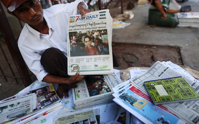 A+news+vendor+displays+local+newspapers+on+a+street+in+Yangon