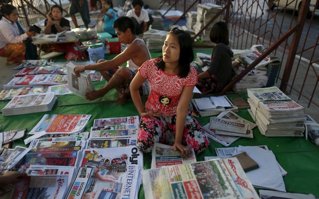 A+woman+sells+newspapers+in+Yangon